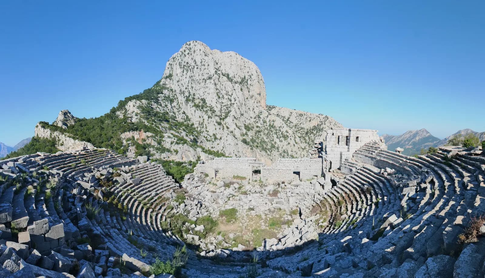 Döşemealtı'ndaki Termessos antik tiyatrosu ve arkasında yükselen Güllük Dağı